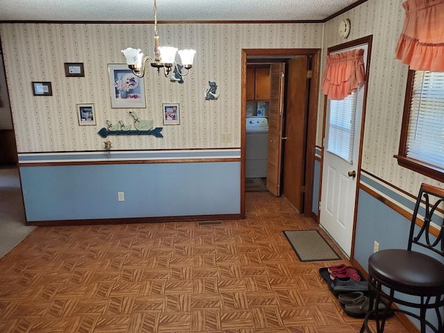 2055 Chisholm Rd, Iron City, TN 38463 - dining area featuring a chandelier, a textured ceiling, washer / dryer, and ornamental molding