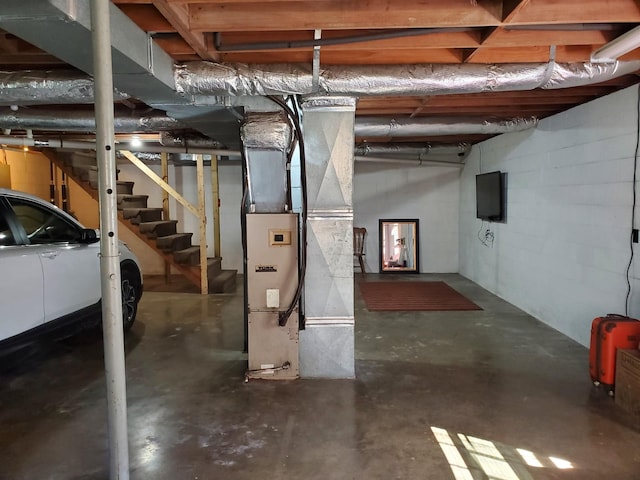 2055 Chisholm Rd, Iron City, TN 38463 - unfinished below grade area featuring heating unit and stairway