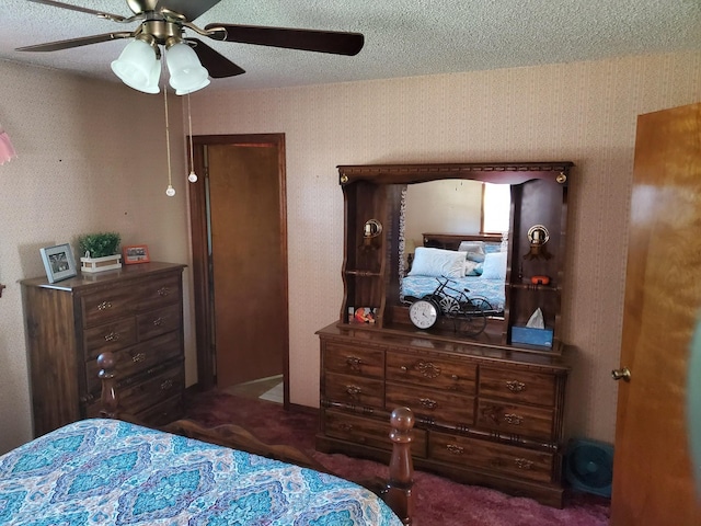 carpeted bedroom with ceiling fan and a textured ceiling