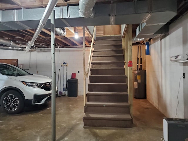 2055 Chisholm Rd, Iron City, TN 38463 - unfinished below grade area with water heater, stairs, and concrete block wall