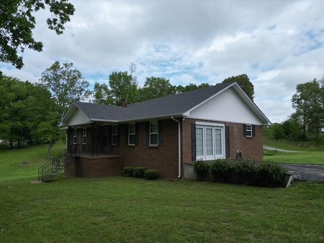 2055 Chisholm Rd, Iron City, TN 38463 - view of side of home featuring brick siding, a yard, a porch, a shingled roof, and a chimney