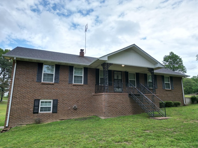 2055 Chisholm Rd, Iron City, TN 38463 - single story home with brick siding, a front lawn, stairs, and covered porch