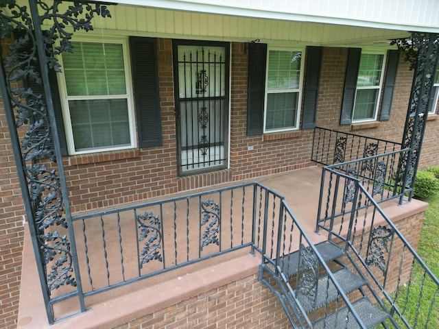 2055 Chisholm Rd, Iron City, TN 38463 - doorway to property with covered porch and brick siding