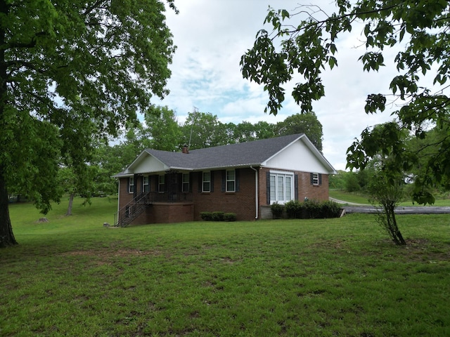 2055 Chisholm Rd, Iron City, TN 38463 - view of front facade with brick siding, a front yard, and stairway