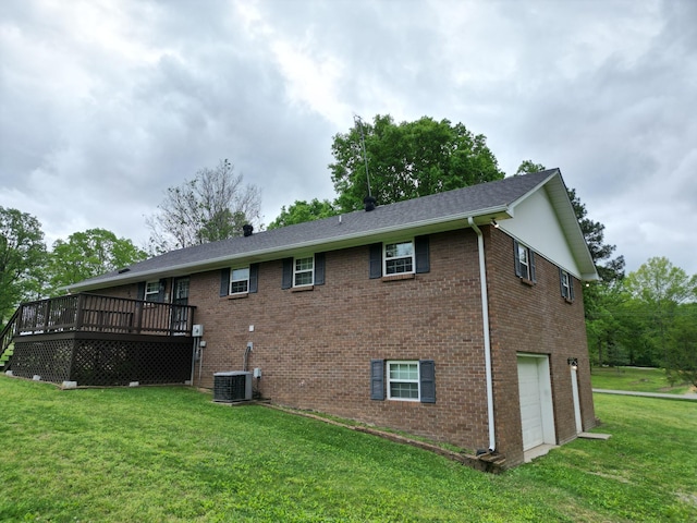 2055 Chisholm Rd, Iron City, TN 38463 - rear view of property featuring a garage, a wooden deck, brick siding, and a lawn