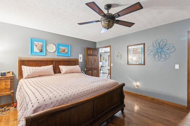 bedroom featuring a textured ceiling, ceiling fan, and dark wood-type flooring