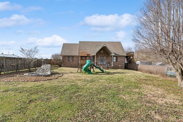 back of house with a yard