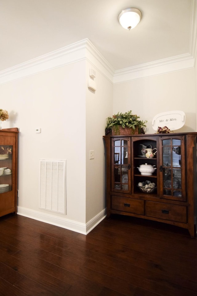 corridor featuring dark hardwood / wood-style floors and ornamental molding