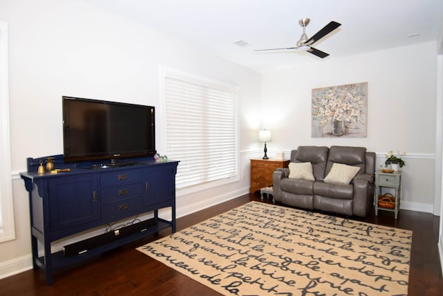 living room featuring ceiling fan and dark hardwood / wood-style flooring