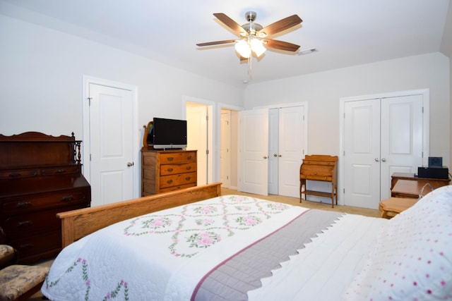 bedroom with two closets and ceiling fan