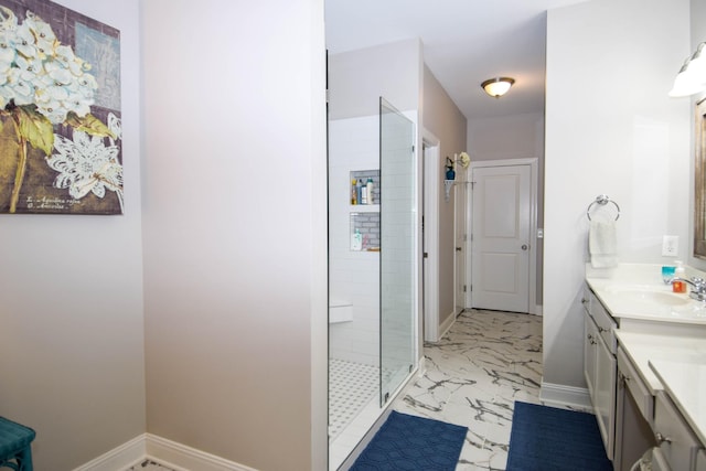 bathroom featuring tiled shower and vanity