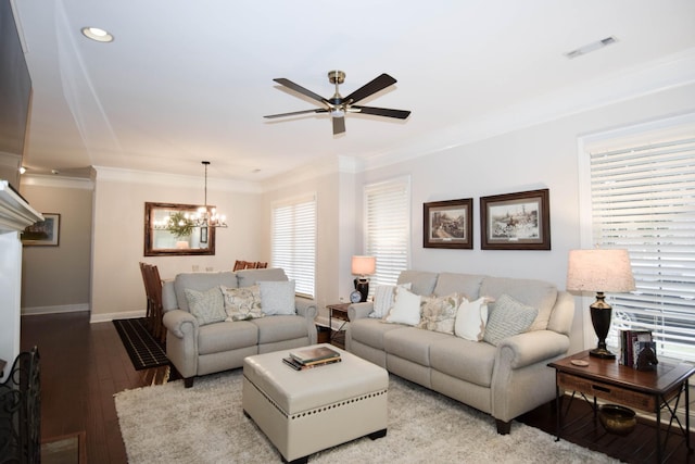 living room featuring ceiling fan with notable chandelier, light hardwood / wood-style flooring, a wealth of natural light, and ornamental molding