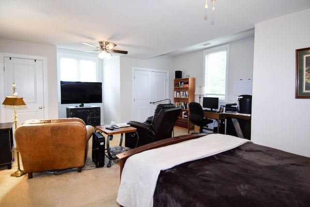 bedroom with ceiling fan and light colored carpet