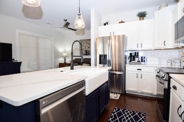 kitchen featuring dark hardwood / wood-style flooring, decorative light fixtures, decorative backsplash, white cabinets, and appliances with stainless steel finishes