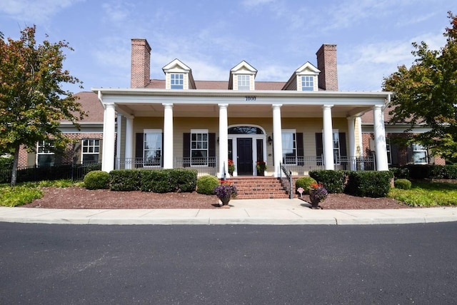 neoclassical home featuring a porch