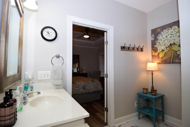 bathroom with ceiling fan, vanity, and ornamental molding