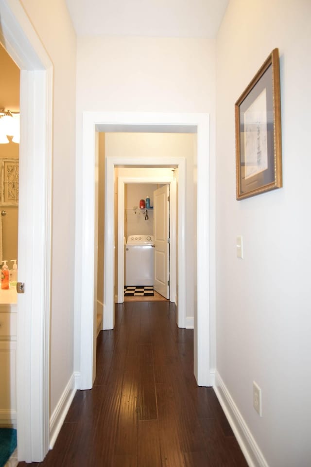 hall featuring washer / clothes dryer and dark wood-type flooring