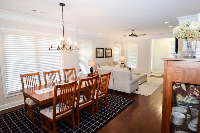 dining space with crown molding, dark hardwood / wood-style flooring, and ceiling fan with notable chandelier