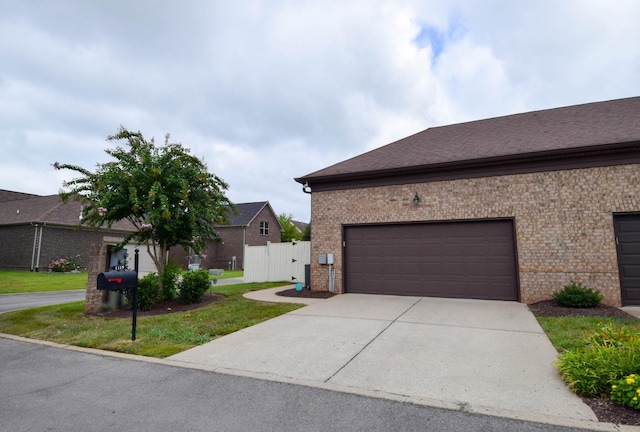 view of property exterior featuring a yard and a garage