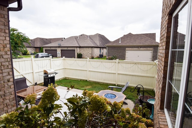 view of patio with a fire pit and area for grilling