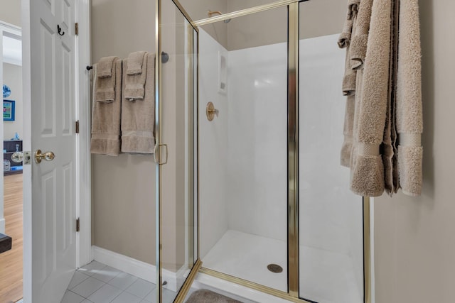 bathroom with tile patterned floors and an enclosed shower