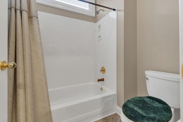 bathroom with toilet and shower / tub combo with curtain