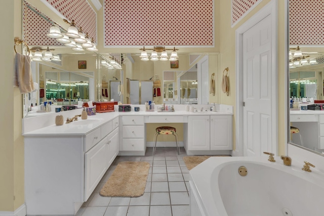 bathroom featuring shower with separate bathtub, vanity, and tile patterned floors