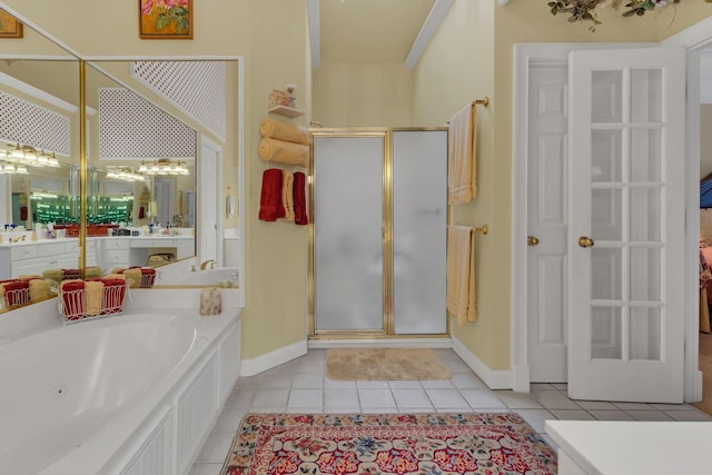 bathroom with tile patterned floors, vanity, and plus walk in shower