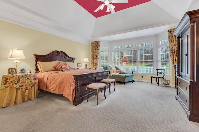 bedroom with a raised ceiling, ceiling fan, carpet, and ornamental molding