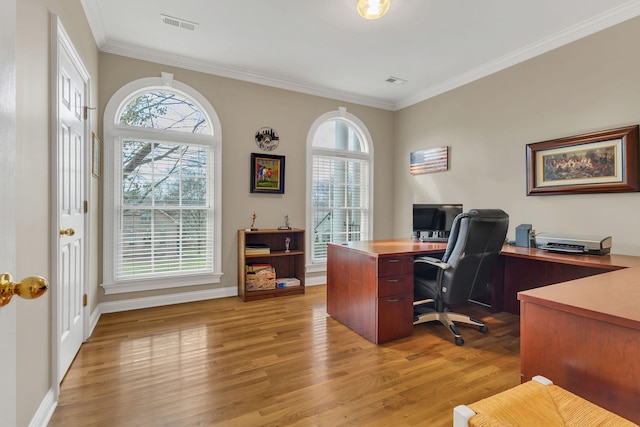 office space with plenty of natural light, light wood-type flooring, and ornamental molding