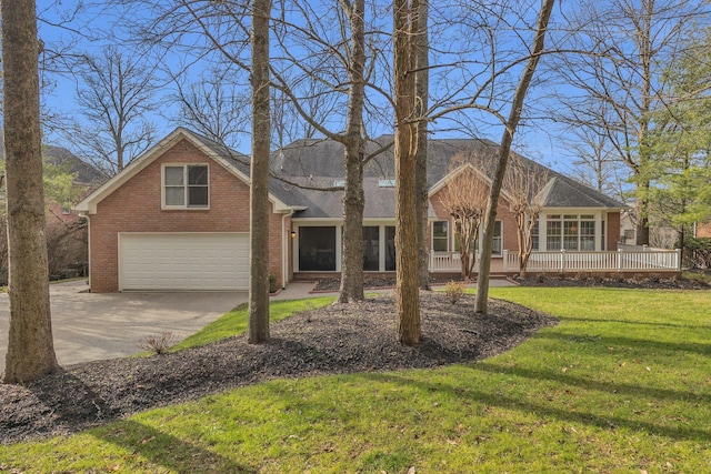 view of front of property with covered porch, a front yard, and a garage