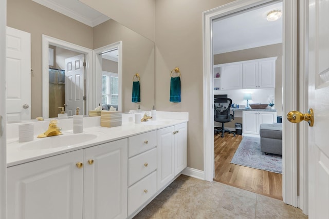 bathroom featuring tile patterned flooring, vanity, and ornamental molding