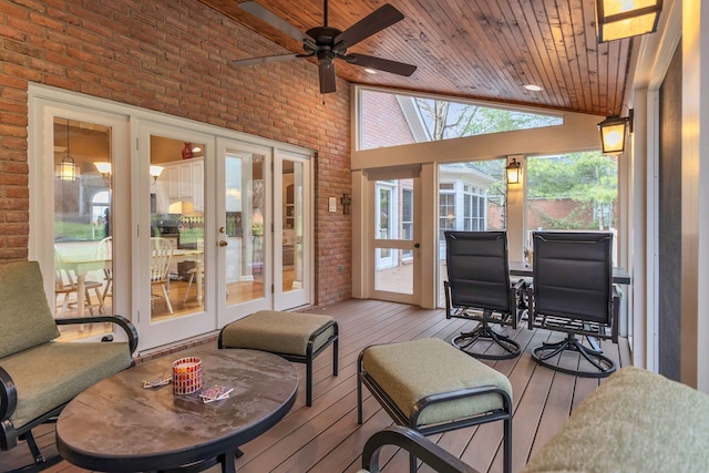 sunroom / solarium with ceiling fan, wood ceiling, and lofted ceiling