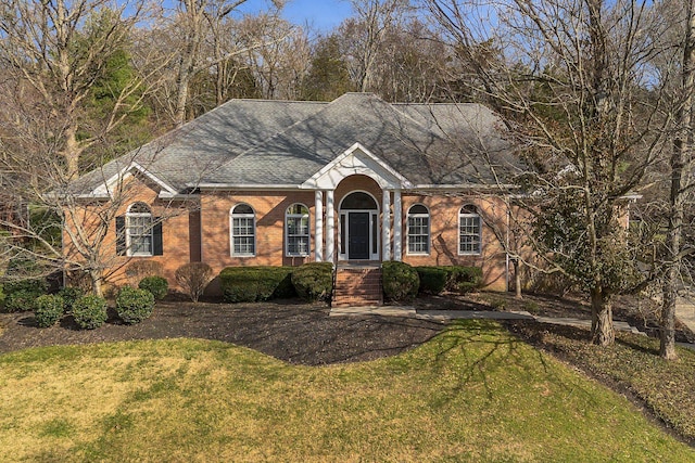 ranch-style home featuring a front yard