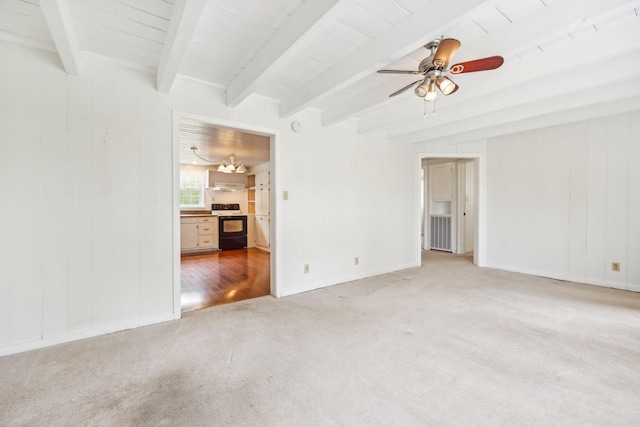 carpeted spare room with ceiling fan and beamed ceiling