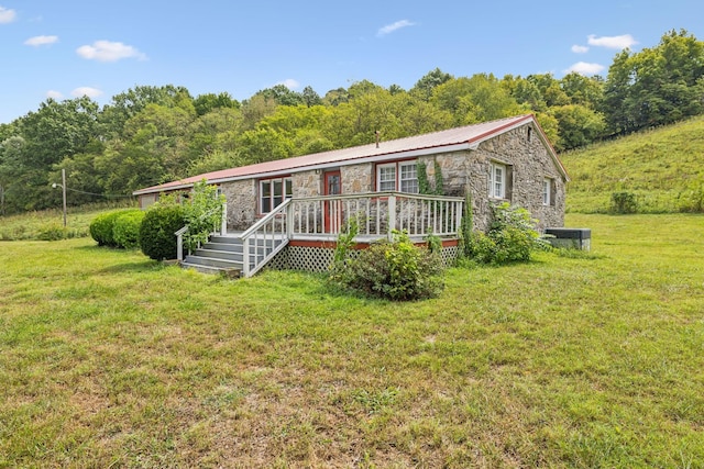 ranch-style house with a front yard and a deck