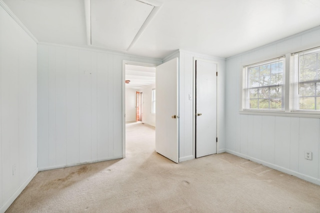 spare room featuring light colored carpet