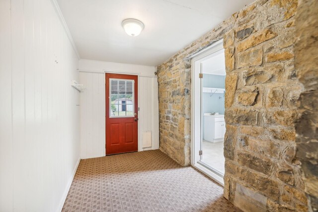 doorway with light colored carpet and sink