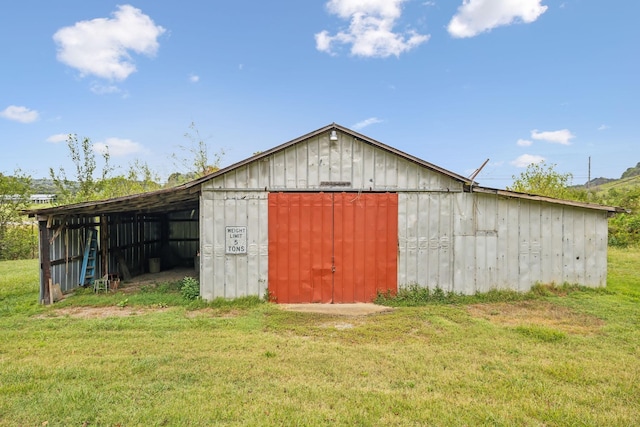 view of outbuilding with a lawn