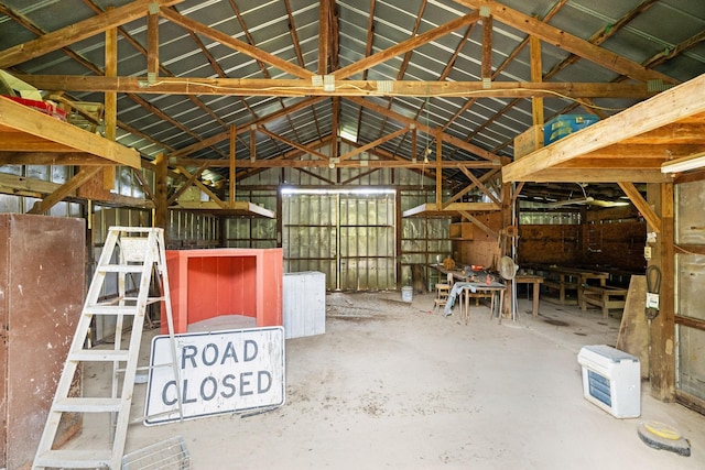 misc room featuring concrete flooring and vaulted ceiling