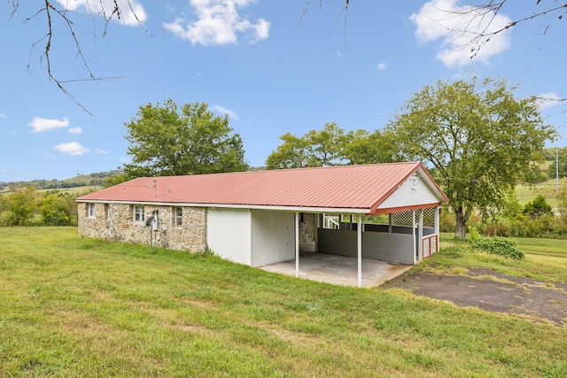 rear view of house with a patio area and a yard