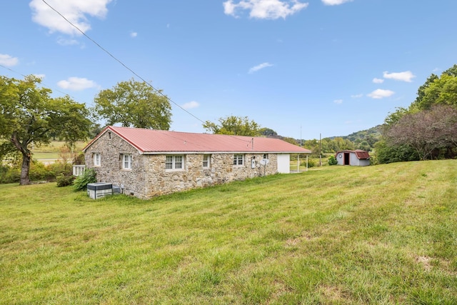 rear view of property featuring a yard