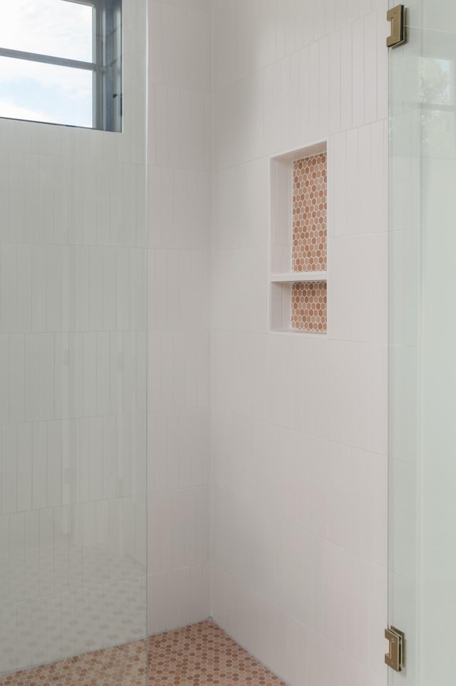 bathroom with tiled shower