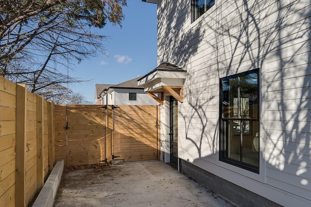 view of property exterior with a patio area