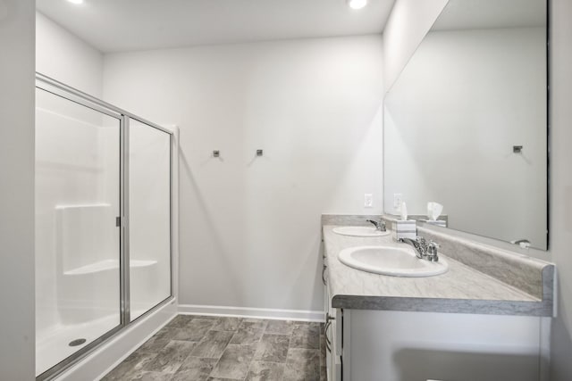 bathroom with a shower with door and vanity