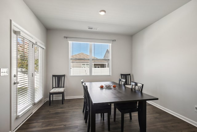 dining area with dark hardwood / wood-style floors