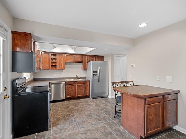 kitchen featuring a kitchen bar, sink, and appliances with stainless steel finishes