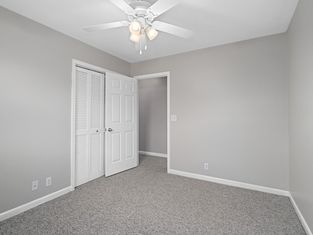 unfurnished bedroom with carpet, ceiling fan, and a closet