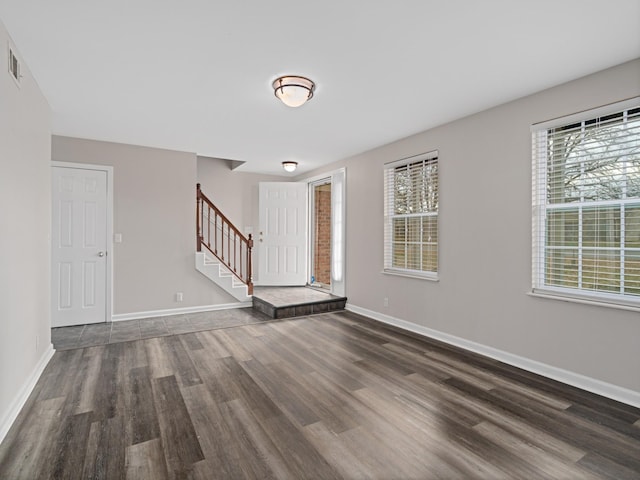 interior space with a healthy amount of sunlight and dark hardwood / wood-style floors