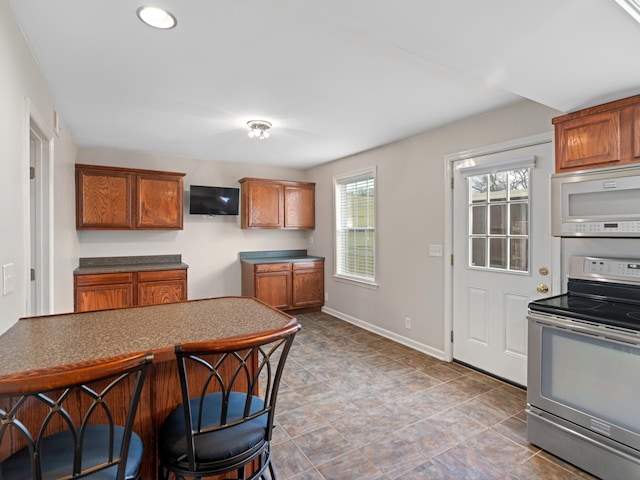 kitchen with built in microwave and electric stove